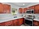 The lovely kitchen features stainless steel appliances, hardwood floors, and wooden cabinets at 1377 Beagle Run, Salisbury, NC 28146