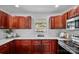 A bright kitchen with stainless steel appliances, wood cabinets, and sleek white countertops at 1377 Beagle Run, Salisbury, NC 28146