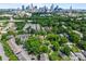 Aerial view of the city skyline with surrounding neighborhood and mature trees at 1556 Walnut View Dr, Charlotte, NC 28208
