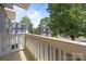 Enjoy the neighborhood views from this inviting balcony with a white railing and string lights at 1556 Walnut View Dr, Charlotte, NC 28208