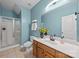 Well-lit bathroom with a glass door shower, white toilet and vanity with a wooden cabinet at 1556 Walnut View Dr, Charlotte, NC 28208