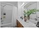 Well-lit bathroom features a double vanity, bathtub with shower, and ample mirror space at 1556 Walnut View Dr, Charlotte, NC 28208