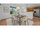 Bright dining area features modern lighting, large windows, and a stylish table set for six guests at 1556 Walnut View Dr, Charlotte, NC 28208
