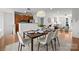 Bright dining area featuring a modern table set and stylish decor adjacent to the open concept living space at 1556 Walnut View Dr, Charlotte, NC 28208