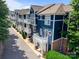 Townhome exteriors with balconies, blue siding, and well-maintained landscaping at 1556 Walnut View Dr, Charlotte, NC 28208
