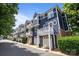 Street view of the homes, showcasing balconies and one-car garages at 1556 Walnut View Dr, Charlotte, NC 28208