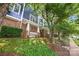 Townhome with blue siding and brick accents, surrounded by lush greenery at 1556 Walnut View Dr, Charlotte, NC 28208