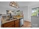 Cozy kitchen features granite counters, stainless appliances and a light-filled window at 1556 Walnut View Dr, Charlotte, NC 28208