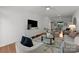 Bright living room boasts hardwood floors, white walls, and an open layout perfect for entertaining at 1556 Walnut View Dr, Charlotte, NC 28208