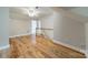 Attic featuring wood flooring, neutral walls, and ample space, perfect for storage or conversion at 2021 Charlotte Dr, Charlotte, NC 28203