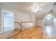 Bright attic space with wood flooring, ceiling fan, and neutral walls offering versatile potential at 2021 Charlotte Dr, Charlotte, NC 28203