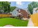Charming backyard featuring lush lawn, brick, stone patio, perfect for outdoor gatherings and relaxation at 2021 Charlotte Dr, Charlotte, NC 28203