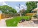 Lush backyard with manicured lawn, stone patio, and decorative plants, perfect for relaxation and outdoor activities at 2021 Charlotte Dr, Charlotte, NC 28203