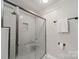Modern bathroom features subway tile shower with glass door, built in niche, and towel bar at 2021 Charlotte Dr, Charlotte, NC 28203