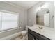 Bright bathroom featuring a modern vanity, toilet, tiled flooring, and a window with bright, natural light at 2021 Charlotte Dr, Charlotte, NC 28203