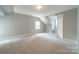 Bright bedroom featuring a large walk-in closet, neutral carpet flooring, and plenty of natural light at 2021 Charlotte Dr, Charlotte, NC 28203