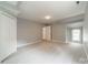 Neutral bedroom with a walk-in closet, plenty of natural light, and easy access to additional spaces at 2021 Charlotte Dr, Charlotte, NC 28203