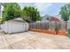 Detached garage with concrete driveway and fenced yard, offering ample parking and storage space at 2021 Charlotte Dr, Charlotte, NC 28203