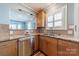 The kitchen has stainless steel appliances, wood cabinets and a stainless steel dishwasher at 2021 Charlotte Dr, Charlotte, NC 28203