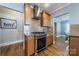 Kitchen features stainless steel appliances, wood cabinets and opens to dining area at 2021 Charlotte Dr, Charlotte, NC 28203