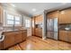 The kitchen has wood cabinets, stainless steel appliances, and hardwood floors at 2021 Charlotte Dr, Charlotte, NC 28203