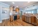 The kitchen has stainless steel appliances, wood cabinets and wood flooring at 2021 Charlotte Dr, Charlotte, NC 28203