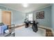 Bright office space with a large window, cozy area rug, modern decor and stylish furnishings at 2021 Charlotte Dr, Charlotte, NC 28203