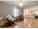 Sitting area adjacent to the main bedroom features chairs and hardwood floors at 2021 Charlotte Dr, Charlotte, NC 28203
