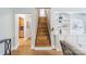 Wooden staircase leading upstairs, complemented by built-in shelving and hardwood floors at 2021 Charlotte Dr, Charlotte, NC 28203