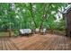 Expansive wooden deck surrounded by lush greenery, offering a serene outdoor living space at 2030 Fasana Rd, York, SC 29745