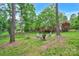 Backyard featuring a circular fire pit with Adirondack chairs surrounded by a lush lawn, trees and a wooden fence at 2030 Fasana Rd, York, SC 29745