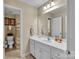 Bright bathroom with white vanity, sink, and a view into an adjacent shower area at 2030 Fasana Rd, York, SC 29745
