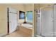 Relaxing bathroom featuring a soaking tub, glass-enclosed shower, and a window with lush greenery views, creating a private retreat at 2030 Fasana Rd, York, SC 29745