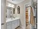 Neutral-toned bathroom featuring a white vanity, a mirror, and an adjacent shower/tub combo at 2030 Fasana Rd, York, SC 29745