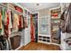 Well-organized walk-in closet featuring built-in shelving, hanging rods, and drawers for ample storage, with hardwood floors at 2030 Fasana Rd, York, SC 29745