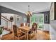 Elegant dining room with a chandelier, large windows, and a table set for six in a classically decorated space at 2030 Fasana Rd, York, SC 29745