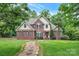 Charming brick home with a manicured lawn and stone pathway leading to a welcoming red door at 2030 Fasana Rd, York, SC 29745