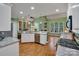 Bright and open kitchen with granite countertops, white cabinets, stainless appliances, and hardwood floors at 2030 Fasana Rd, York, SC 29745