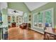 Spacious living room featuring hardwood floors, large windows, and a cozy seating area with a leather sofa at 2030 Fasana Rd, York, SC 29745