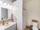 Bright bathroom with a single sink vanity, tiled accents, and a shower with a curtain at 211 Drive Inn Rd, Locust, NC 28097