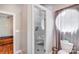 Bathroom showcasing a glass shower door and a round window at 211 Drive Inn Rd, Locust, NC 28097