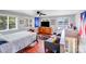 Bedroom featuring a wooden dresser and bed with gray comforter and throw pillows at 211 Drive Inn Rd, Locust, NC 28097