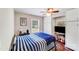 Bedroom with a bed with blue striped comforter, and a flat screen TV at 211 Drive Inn Rd, Locust, NC 28097