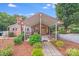 Charming brick home featuring an inviting, covered front entrance and well-manicured landscaping at 211 Drive Inn Rd, Locust, NC 28097