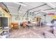Spacious garage equipped with a ping pong table, storage racks, and fitness equipment at 211 Drive Inn Rd, Locust, NC 28097