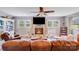 Cozy living room with a brick fireplace, built-in shelves, and comfortable furniture at 211 Drive Inn Rd, Locust, NC 28097