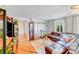 Bright living room featuring hardwood floors, a plush rug, and comfortable leather furniture at 211 Drive Inn Rd, Locust, NC 28097