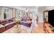 Spacious living room with a plush sectional sofa, hardwood floors, and natural light, perfect for relaxation at 211 Drive Inn Rd, Locust, NC 28097