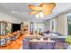 Inviting living room with a grand ceiling fan, hardwood floors, and comfortable leather seating at 211 Drive Inn Rd, Locust, NC 28097