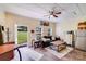 Cozy living room featuring a comfortable sofa, wood floors, and an open doorway to the outdoors at 211 Drive Inn Rd, Locust, NC 28097